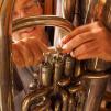 View the image: Hands on tuba valves